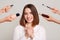 Indoor shot of the hands of several beauticians holding their respective equipment, smiling satisfied female in beauty salon