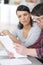 Indoor shot married couple doing paperwork at home