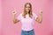 Indoor shot of pleasant attractive friendly-looking girl with tanned skin in casual t-shirt and jeans raising hands