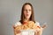 Indoor shot of shocked amazed woman in white t-shirt holding big plate with noodles, looking with big eyes and open mouth, keeps