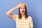 Indoor shot of shocked sad upset teenager girl wearing striped T-shirt and baseball cap, showing facepalm gesture, making mistake