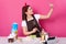 Indoor shot of standing smilling charismatic young lady making selfie at kitchen while cooking new delicious dish, posting photos