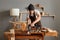 Indoor shot of young adult caucasian carpenter working on woodworking machines in carpentry shop, craftsman sawing wood with an