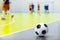 Indoor Soccer Futsal Ball. Indoor Soccer Match in the Background. Indoor Soccer Sports Hall