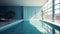 Indoor swimming pool in a luxury urban building. Blue tiled walls and white floor, deck chairs, plants in floor pots