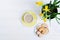 Indoor table setting. Narcissus flower in a pot with cookies and