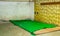 Indoor view of a room inside of a refuge center in Carcelen in the city of Quito with a green blanket in the ground