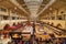 Indoor view of the Stuttgarter Markthalle building with its stalls bursting with life as gourmet food is served at the kiosks