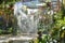 Indoor waterfall curtain amidst hanging plants