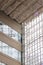 Indoor white metal rafters reflected on glass windows