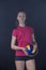 Indoor young volleyball woman player isolated on dark background