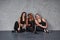 Indoors of nice studio. Group of multi ethnic women sitting against grey background