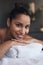 Indulge in a little luxury. Portrait of a young woman lying on a massage bed at a spa.