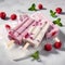 Indulge in Refreshing Raspberry Popsicle Delights on Ice, Surrounded by Juicy Raspberry Fruits