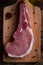 Indulge in the rustic charm of a raw piece of pork loin on a wooden board