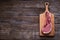 Indulge in the rustic charm of a raw piece of pork loin on a wooden board