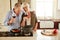 Indulging in a glass of wine while cooking. a senior couple enjoying a glass of wine while cooking supper.