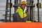 Industial background of african american forklift driver driving forklift a loading area at containers yard and cargo