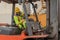 Industial background of african american forklift driver driving forklift a loading area at containers yard and cargo