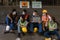 Industrail background of diverse factory workers, labors and engineer with wearing medical mask sitting together in front of
