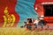 industrial 3D illustration of 3 red modern combine harvesters with Mongolia flag on wheat field - close view, farming concept