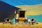 industrial 3D illustration of 4 orange combine harvesters on wheat field with flag background  Bahamas agriculture concept