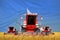 industrial 3D illustration of four bright red combine harvesters on rural field with flag background, Somalia agriculture concept