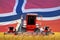 Industrial 3D illustration of four bright red combine harvesters on rye field with flag background, Norway agriculture concept