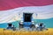 Industrial 3D illustration of four light blue combine harvesters on wheat field with flag background, Luxembourg agriculture