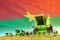 industrial 3D illustration of green wheat agricultural combine harvester on field with Burkina Faso flag background, food industry