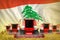 Industrial 3D illustration of a lot of red farming combine harvesters on wheat field with Lebanon flag background - front view,