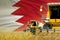 Industrial 3D illustration of three yellow modern combine harvesters with Bahrain flag on rural field - close view, farming