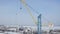 Industrial aerial background with the crane at the construction site. Clip. Winter frozen landscape, concept of heavy