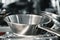 Industrial aluminum colanders on professional kitchen close up