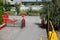 Industrial area. Factory zone. Green trees outdoors. Red stop sign on the road. Pedestrian place