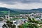 Industrial area. View of the city with factories, buildings and green hills. Pollution and air concept.