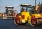 Industrial asphalt paver machine laying fresh asphalt and a Heavy road roller with vibration roller compactor press new