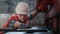 Industrial background of caucasian mechanic engineer checking precision of steel plate cutting machine in metal work and machine