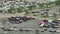 Industrial big rig hauler semi trucks loaded with used cars ready for transporting. Dealer parking lot with vehicles for