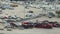 Industrial big rig hauler semi trucks loaded with used cars ready for transporting. Dealer parking lot with vehicles for
