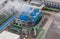 Industrial blue cooling tower at a chemical plant.