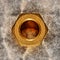 Industrial Brass Nut on Grunge Steel Background