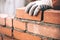 Industrial bricklayer installing bricks on construction site