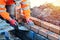 Industrial bricklayer laying bricks on cement mix on construction site. Fighting housing crisis by building more affordable houses