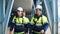 Industrial builder group in protective helmet uniform walking refinery chemical plant control