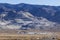 Industrial buildings built next to large tailing piles on a mountain in Gabbs Nevada