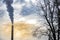 Industrial chimney, thermal power plant, pollution in the air, steam cooling tower in Graz, Styria region, Austria, at sunset