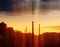 Industrial chimneys covered by grey clouds backdrop