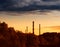 Industrial chimneys covered by grey clouds background