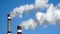 Industrial chimneys emits toxic pollutants into the sky polluting the environment